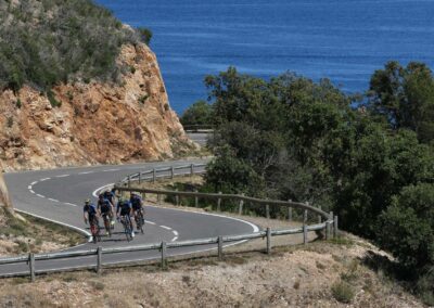 Group of road cyclists along Mediterranean coast